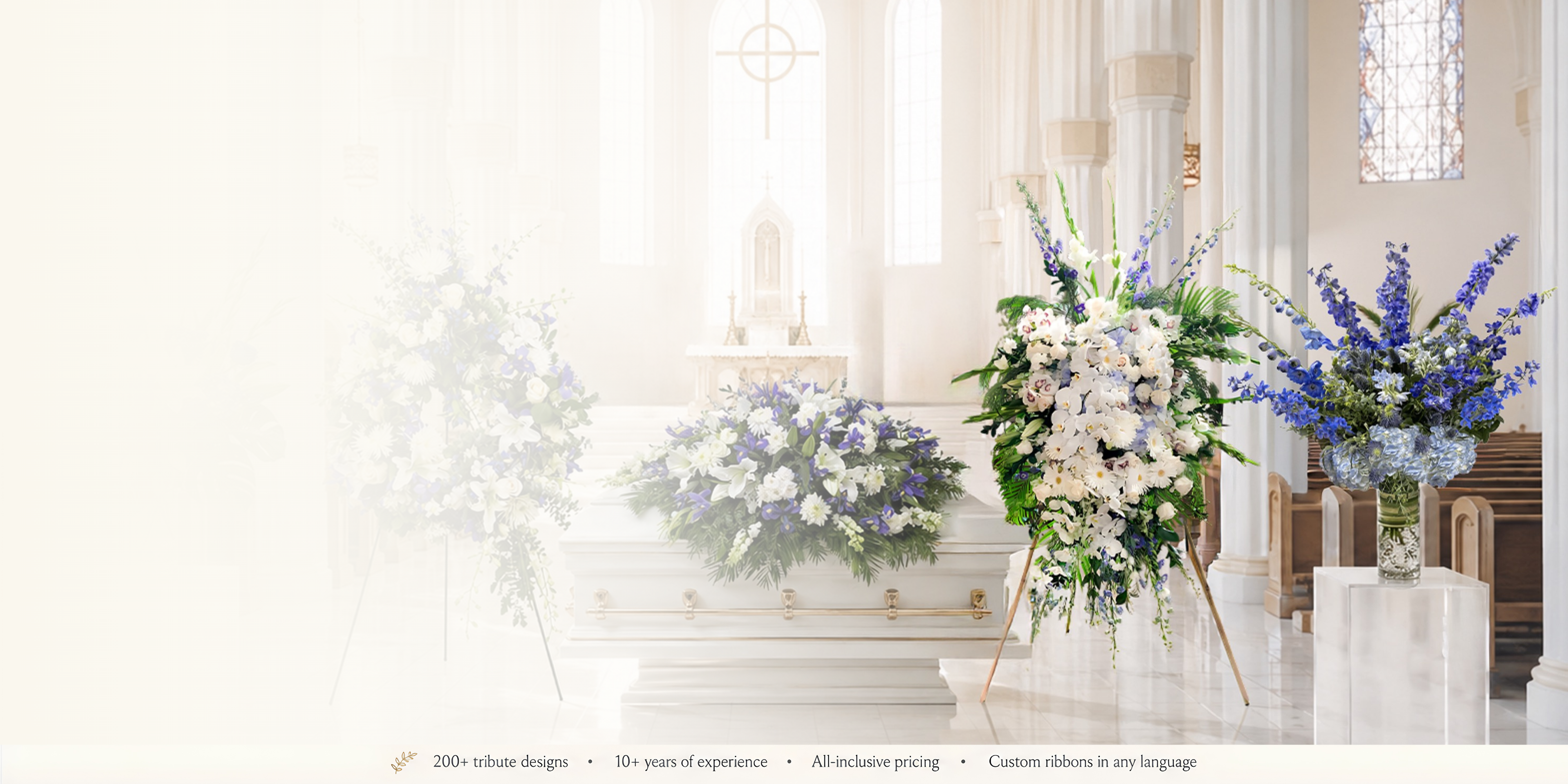 A softly lit chapel interior with a white casket, floral arrangements in white and blue-purple tones, and a stained-glass window in the background.