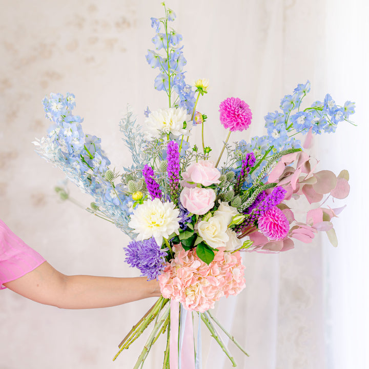 Holding Pastel themed designers choice bouquet
