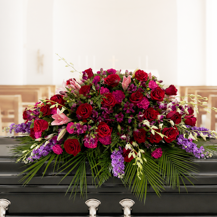 Casket spray with Colourful flowers sitting on a casket